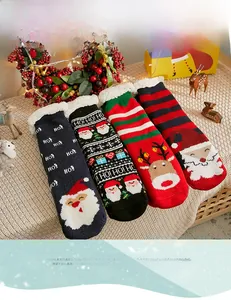 Detail of four pairs of warm winter fleece socks with festive Christmas reindeer patterns