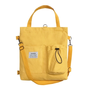 Yellow canvas crossbody bag with adjustable straps and front pockets in a minimalist style