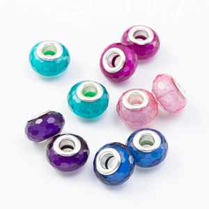 DIY charm bracelet set with faceted colorful beads and silver metal cores on white background