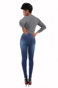 Detail of dark blue skinny jeans with wash effect and grey ribbed knit top on model