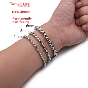 Detail of titanium steel box chain bracelets in 4mm, 5mm, and 6mm widths on wrist