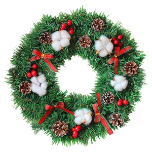 Classic Christmas wreath with pine cones, red berries, and plaid bow on white background