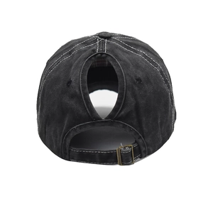 Detail of washed cotton baseball cap with high ponytail hole and metal buckle strap