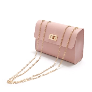 Close-up of pink PU leather mini bag with gold chain strap and square metal buckle
