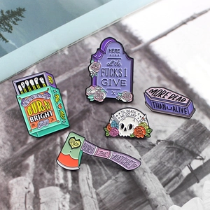 5-piece gothic enamel pin set featuring skulls, matchbox and axe with artistic slogans