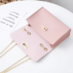 Pink PU leather crossbody phone bag detail with gold metal lock and fine chain strap