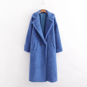 Detailed view of royal blue faux fur coat featuring notched lapels and button closure