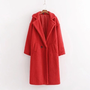 Detailed view of long red teddy coat with wide lapels and buttons on hanger