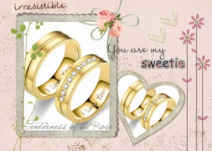 Close-up of gold couple rings set with I Love You engraving and sparkling crystal inlay