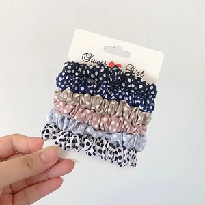 Set of 5 polka dot chiffon scrunchies in navy, blue, pink, beige, and white colors