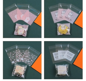 Detail of four semi-transparent self-adhesive snack bags with cute cat and bear patterns