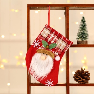 Christmas stocking with Santa Claus design, bells and snowflakes on a warm wood background