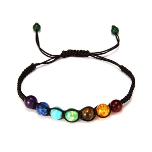 Detail of adjustable woven cord bracelet with seven colorful chakra gemstone beads