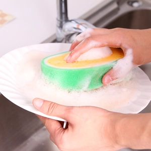 Thickened fruit-shaped kitchen sponge cleaning a ceramic plate with rich soapy foam