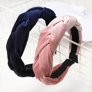 Detail of dark blue and dusty pink velvet braided headbands with thick woven texture