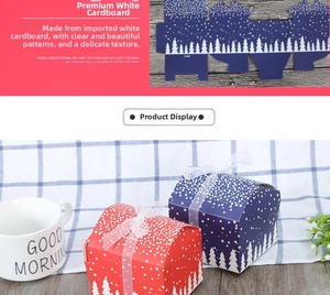Detail of red and blue Christmas apple gift boxes with snow forest patterns and silk bows