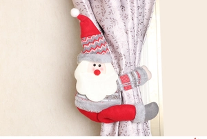 Detail of plush Santa Claus curtain tieback showing knitted texture and secure hold