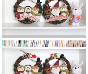 Detailed view of handmade Christmas rattan wreaths featuring plush snowmen and reindeers