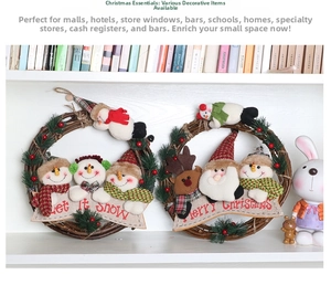 Detailed view of handmade Christmas rattan wreaths with Snowman and Santa plush figures
