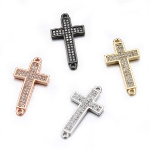 Macro detail of cross jewelry connectors with micro-paved cubic zirconia in four metal finishes