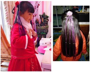 Detail of child wearing colorful gradient braided wig hair tie with flower ornament
