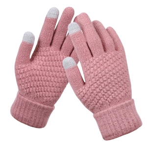 Detailed view of pink knitted gloves with touch screen fingertips and diamond pattern