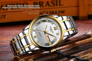 Close-up of luxury gold-tone men's watch with Roman numerals and day-date display