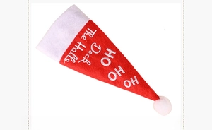 Close-up of red felt Christmas hat cutlery holder with HO HO HO Deck The Halls embroidery