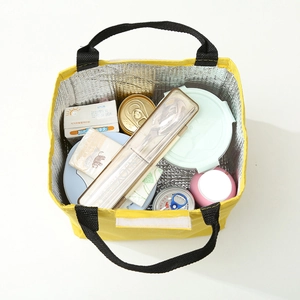 Yellow insulated lunch bag with thick aluminum foil lining showing spacious storage capacity