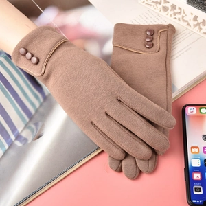 Detailed view of winter warm knitted touchscreen gloves with decorative buttons in brown