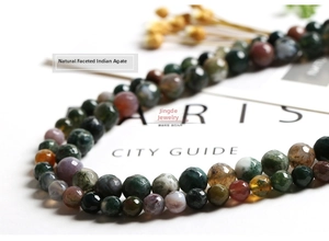 Detailed view of faceted Indian agate beads with natural green and brown earthy tones