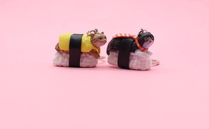 Detailed view of cute sushi cat keychains featuring salmon and tamago nigiri designs