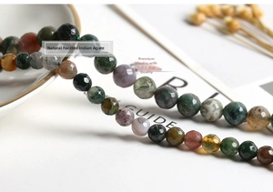 Close-up of natural faceted Indian agate beads with diverse mossy green textures