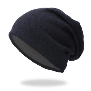Detail view of the soft knitted texture and grey lining of this black slouchy beanie