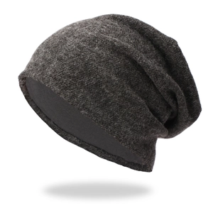 Detailed close-up of thick knitted fabric and soft inner edge on dark grey beanie