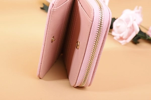 Detail of pink quilted PU leather wallet featuring multiple card slots and zipper compartment
