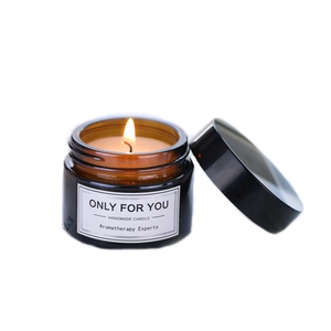 Brown glass jar soy wax aromatherapy candle with a warm flickering flame and clean label