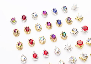 Detailed macro view of assorted K9 crystal nail charms with alloy metal bases
