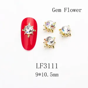 Macro detail of sun flower nail art jewelry with K9 crystal stone and gold metal claw
