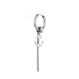 Close-up of silver stainless steel hoop earring with anchor charm and long chain detail