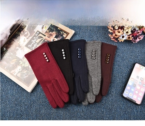 Detail view of women's thermal winter gloves in five colors with button decorations
