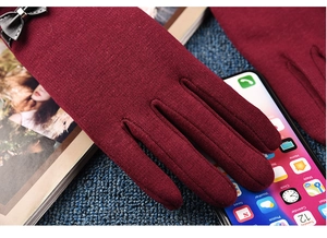 Burgundy thermal gloves with touch screen feature and black leather bow detail