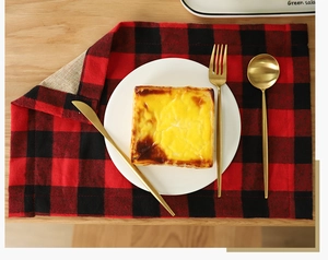 Close-up of red and black plaid placemat with classic linen texture for Christmas dining
