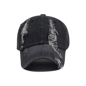 Distressed black denim baseball cap with vintage frayed holes and curved brim design