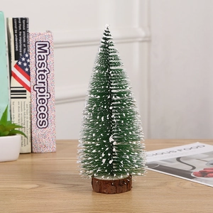 Miniature artificial Christmas tree with snow effect on a wooden base for table decoration