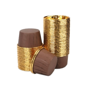 Detail of gold and brown aluminum foil cupcake liners with rolled edges for baking muffins