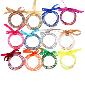 Detailed grid view of assorted glitter jelly bracelets with elegant satin bow accents
