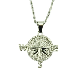 Detailed view of silver compass pendant necklace with shimmering crystal rhinestones