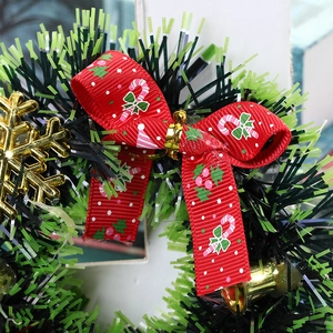 Christmas wreath featuring red printed bow, golden snowflakes and metallic bells decoration