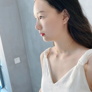 Detail of 925 sterling silver galaxy choker necklace worn by a model on a lifestyle background